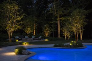 Backyard Pool Outdoor living space enhanced with Charlotte landscape lighting